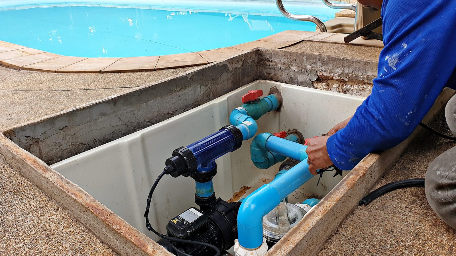 Technician repairing a pool pump in Mission Viejo, CA by Saddleback Mountain Pool and Spa Service